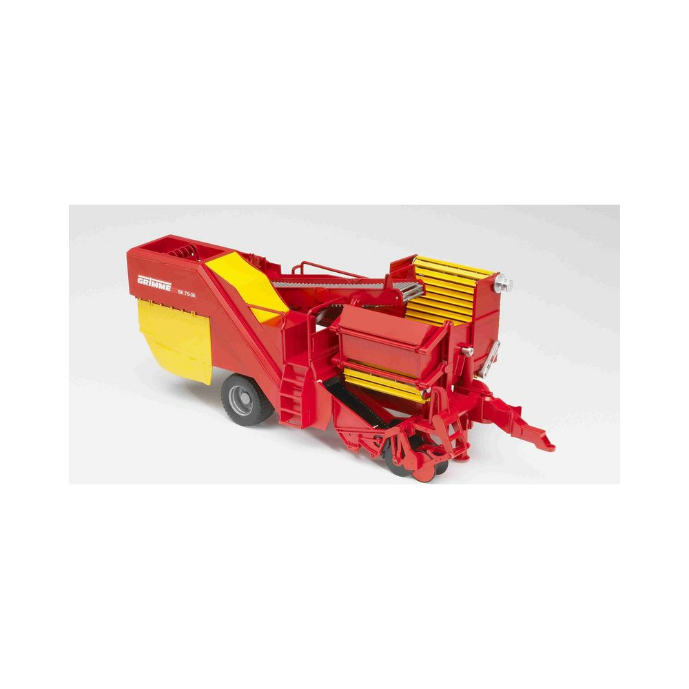Ein roter und gelber Kartoffelroder mit GRIMME-Logo.