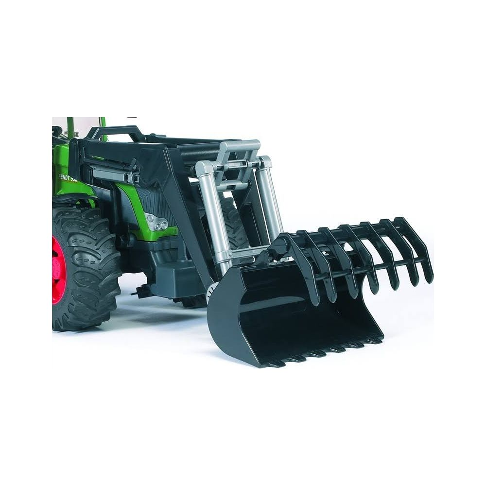 Zielny traktor zabawkowy z czarnym ładowaczem czołowym i zębami.