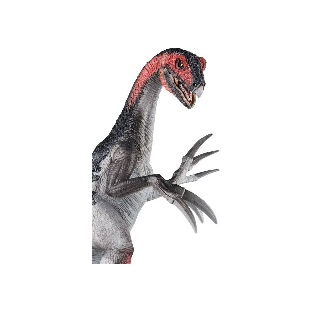 Grauer Dinosaurier mit rotem Kopf und langen Krallen, der nach rechts schaut.