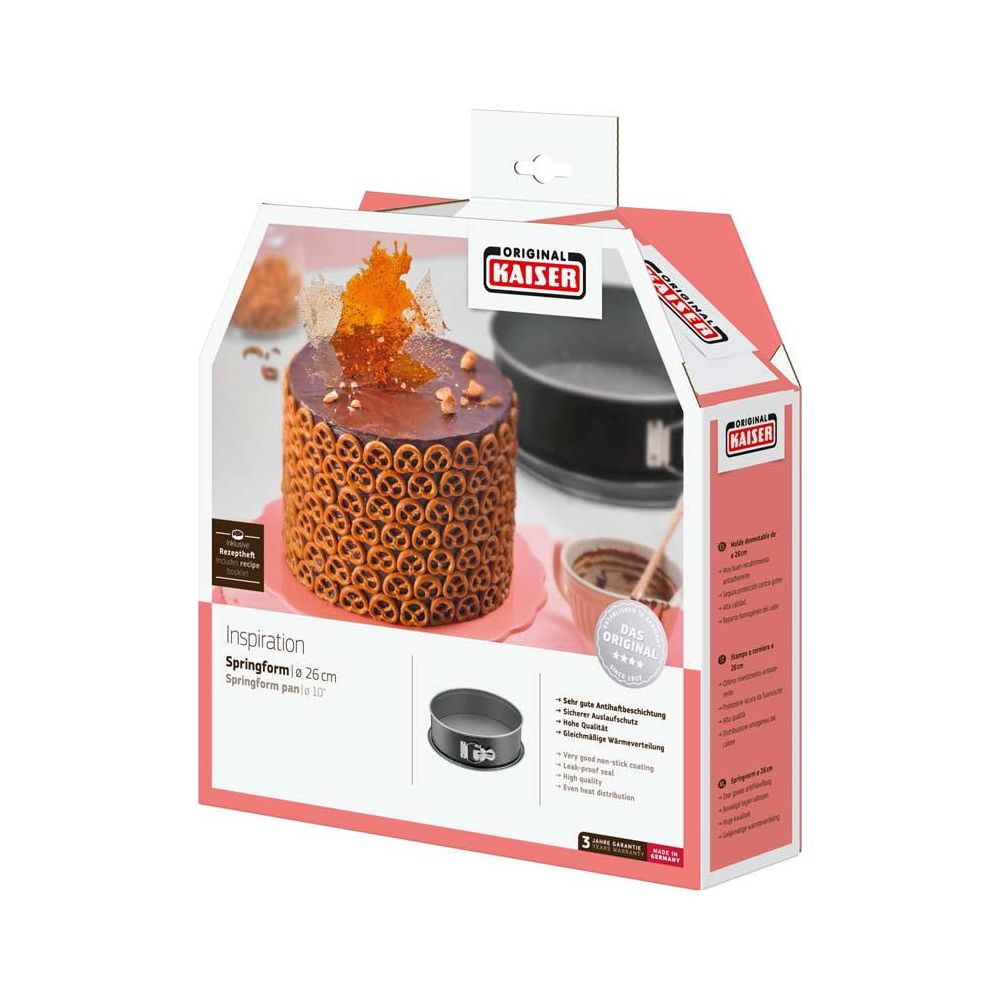 Pudełko tortownicy Kaiser z udekorowanym ciastem i detalami.