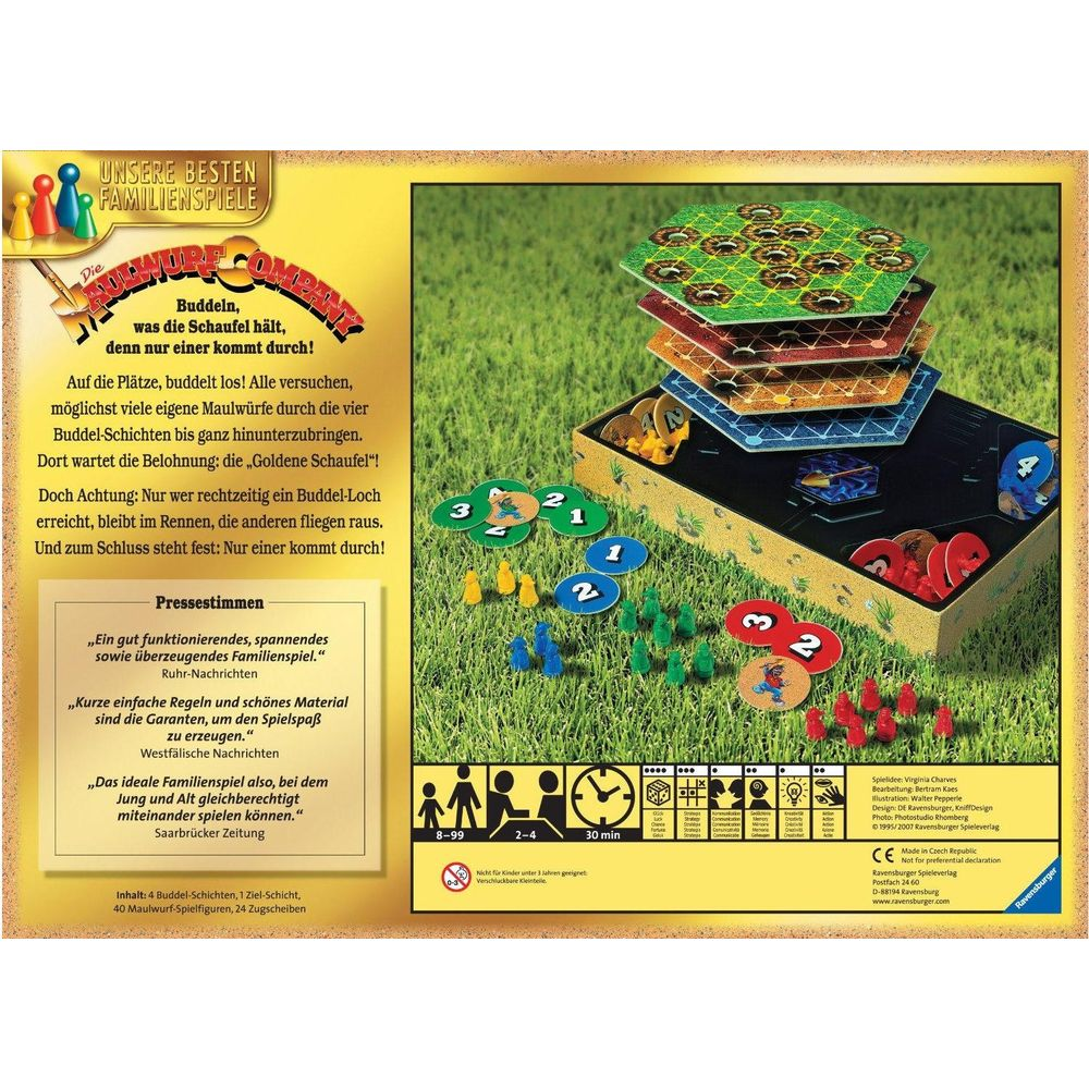 Gioco da tavolo con figure di talpa e strati colorati sull'erba verde.