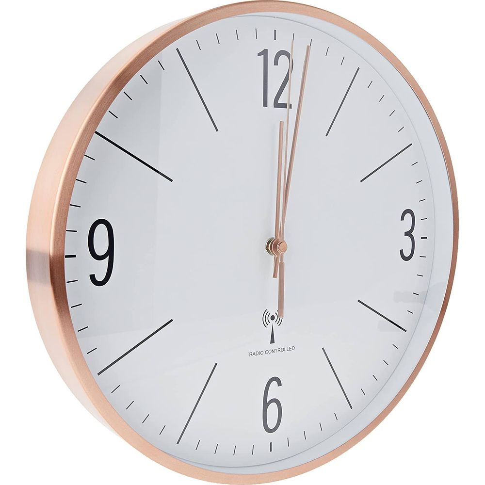 Eine Wanduhr mit roségoldfarbenem Rahmen und weißem Zifferblatt.