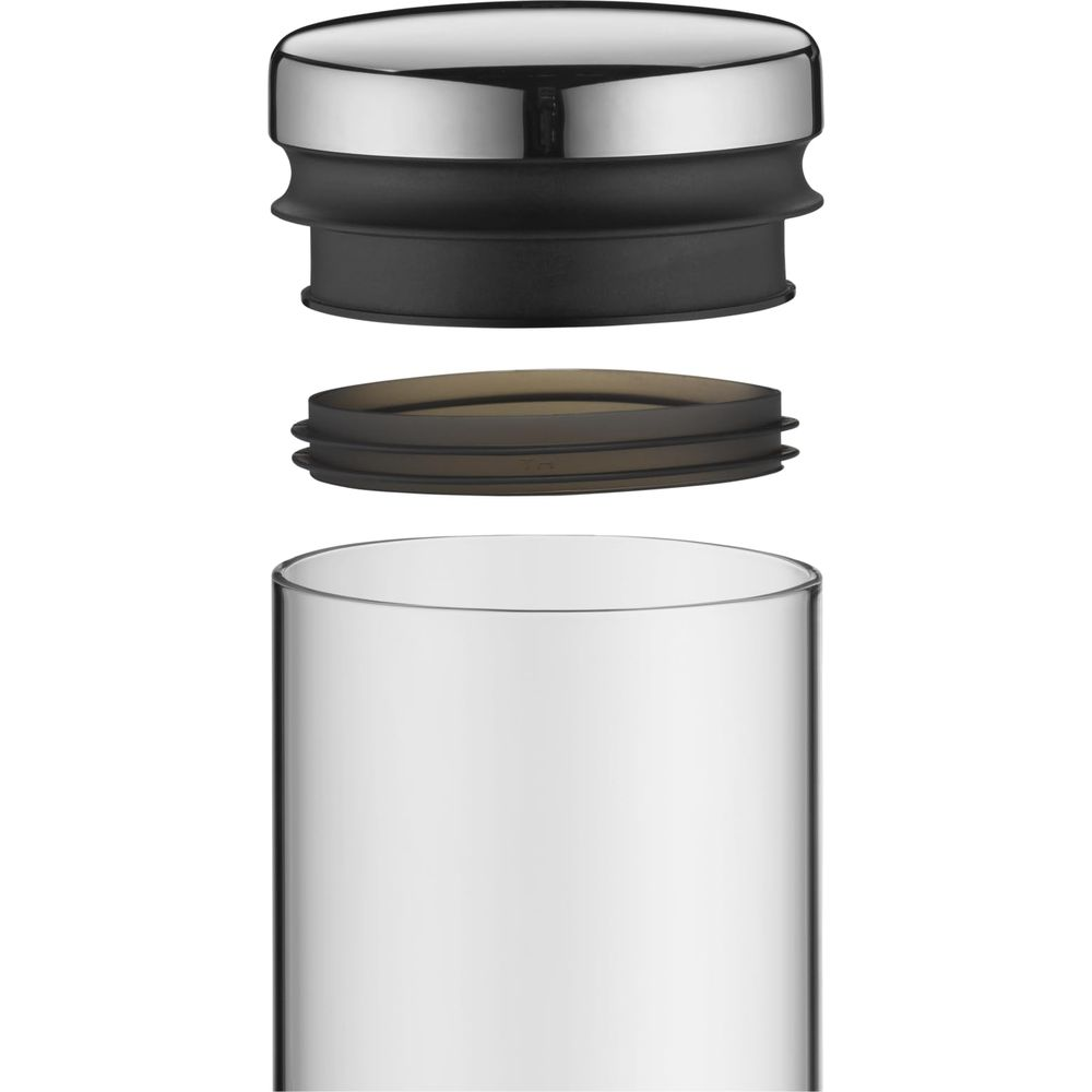 Ein silberner Deckel, ein schwarzer Ring und ein transparenter Ring über einem Glasbehälter.