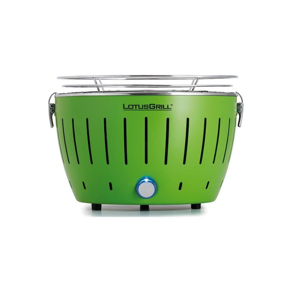 Zielony grill Lotus z srebrnym rusztem i niebieskim pokrętłem.