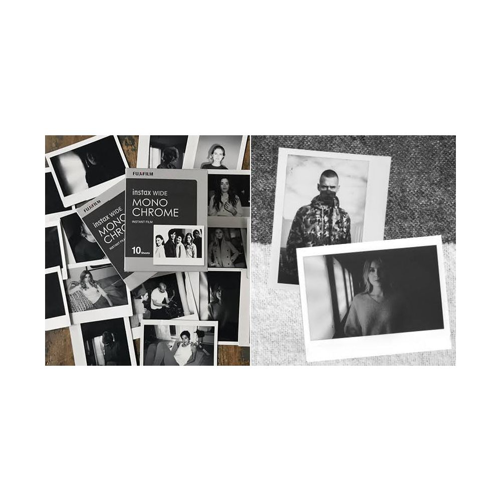 Schwarz-Weiß-Instax-Wide-Filmbox und verstreute Fotos, einige in Rahmen.