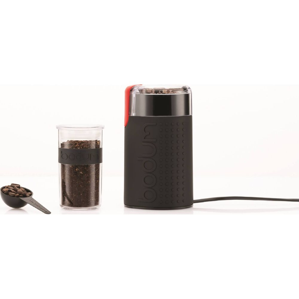 Schwarzer Kaffeemühlen-Set mit Bohnen in Löffel und Behälter.
