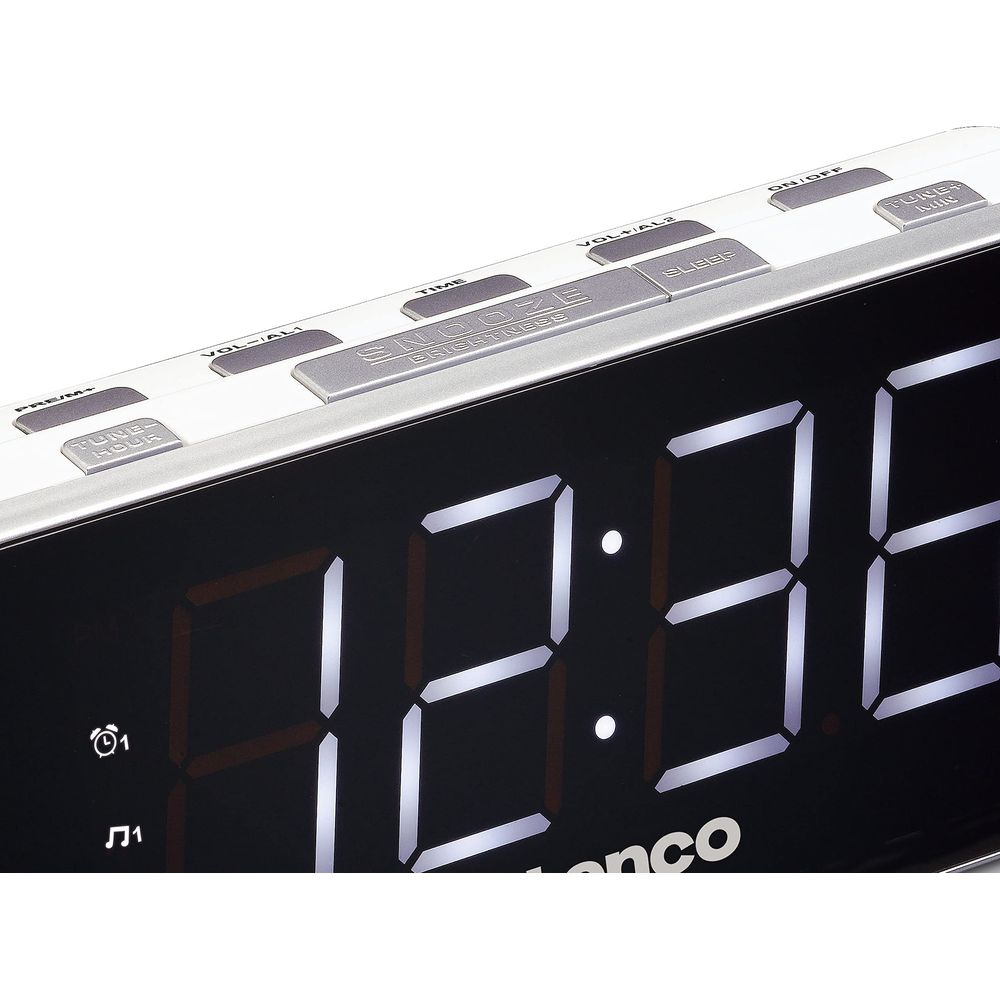 Zegar cyfrowy z czerwonym wyświetlaczem pokazuje 12:35. Przyciski do drzemki, czasu i głośności.