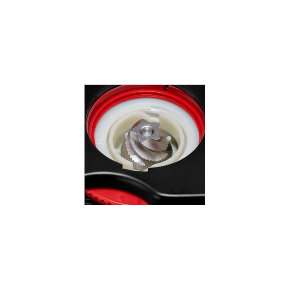 Zbliżenie żarna młynka do kawy z metalowymi ostrzami na białym i czerwonym tle.