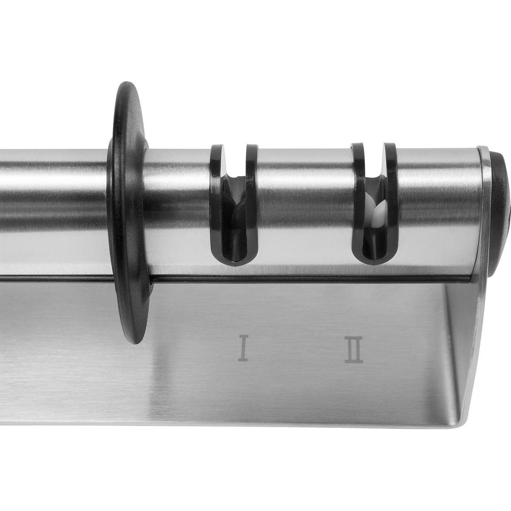 Ein Metallschärfer mit zwei Schlitzen, markiert mit I und II.