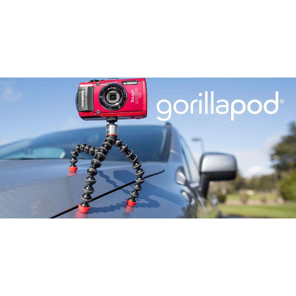 Red Olympus camera on a flexible tripod on a car.