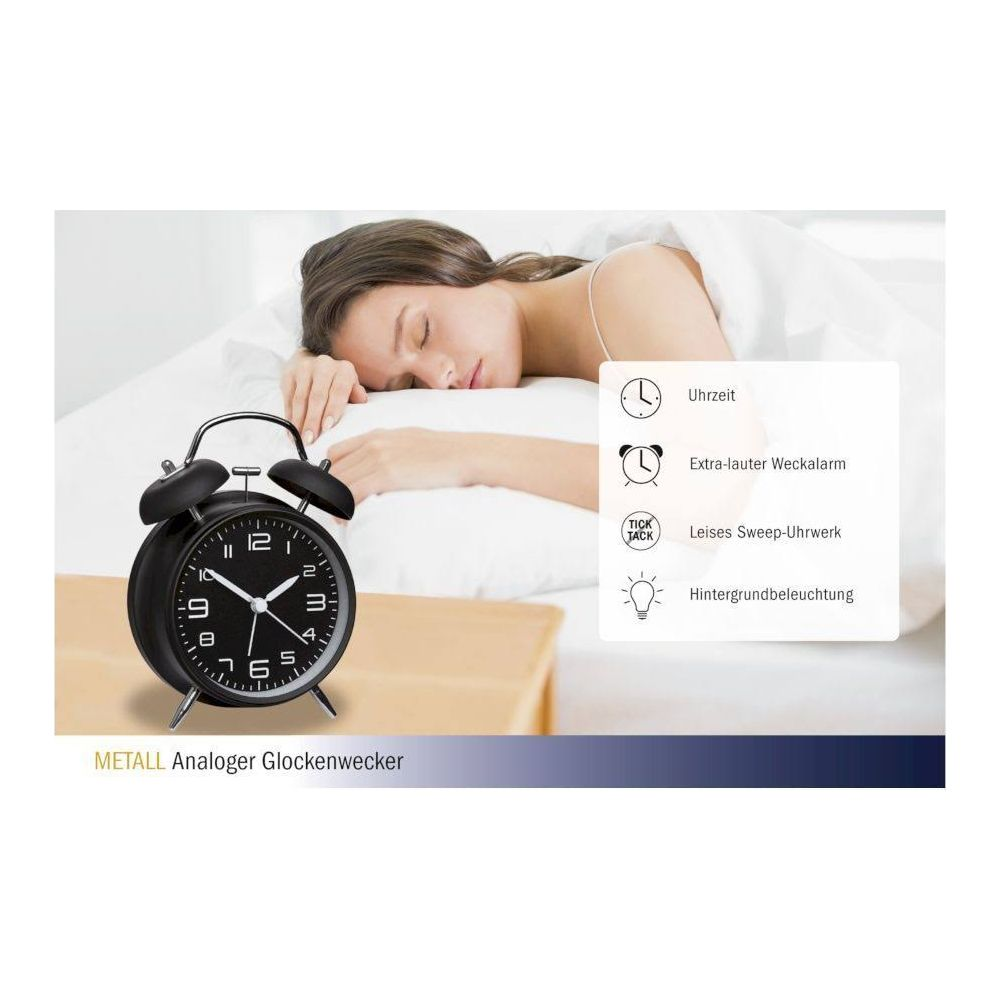 Ein schwarzer Wecker mit zwei Glocken schläft eine Frau im Bett.