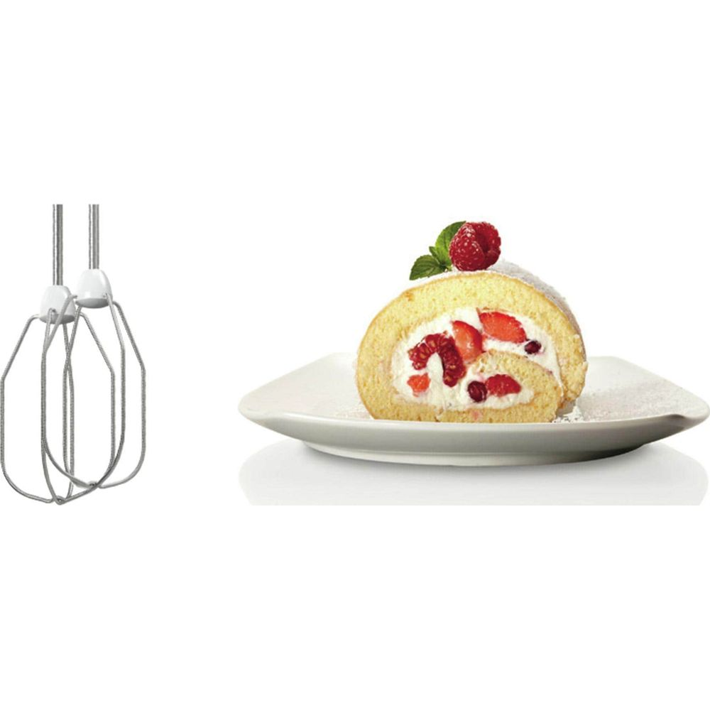 Mixer beaters and a slice of roulade with berries on a plate.