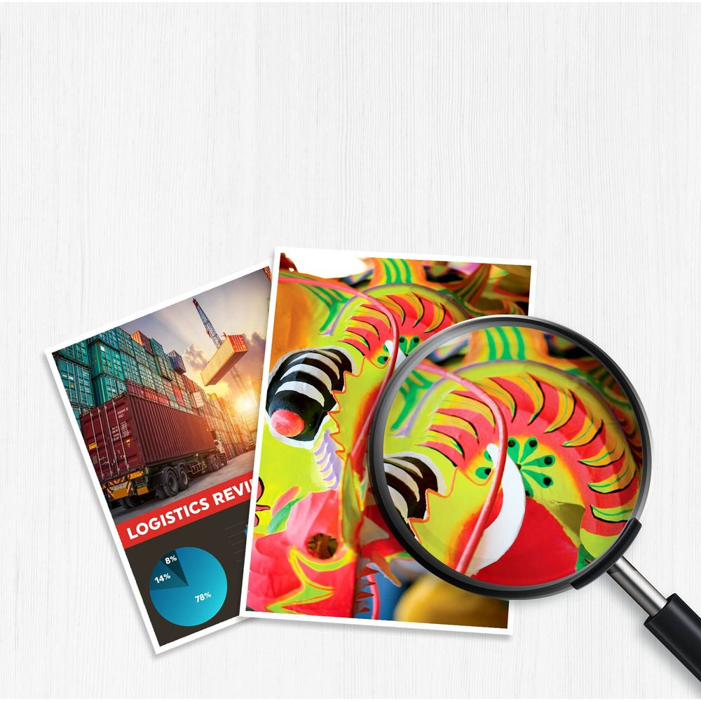 Zbliżenie kolorowych masek smoka przez lupę, obok raportu logistycznego.