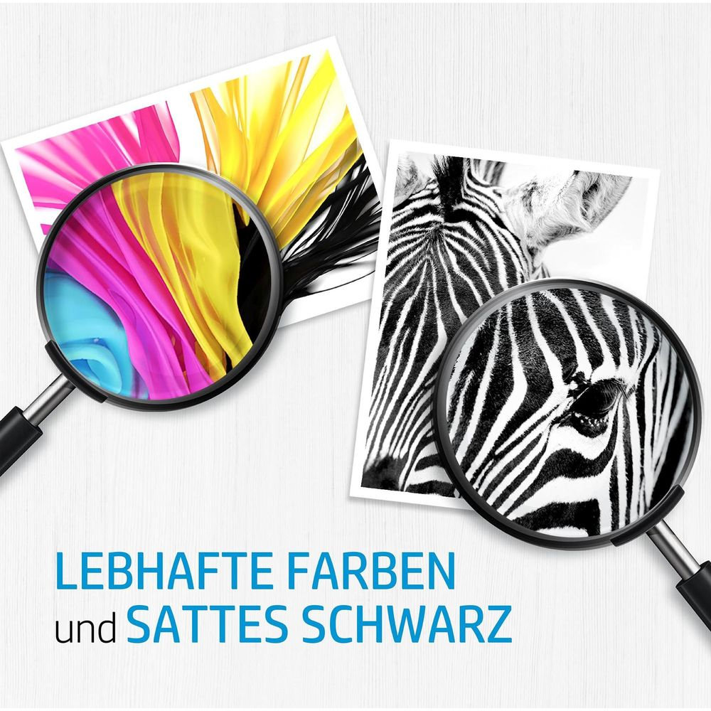 Lupa pokazuje żywe kolory i szczegół zebry. Tekst: Żywe kolory i bogata czerń.