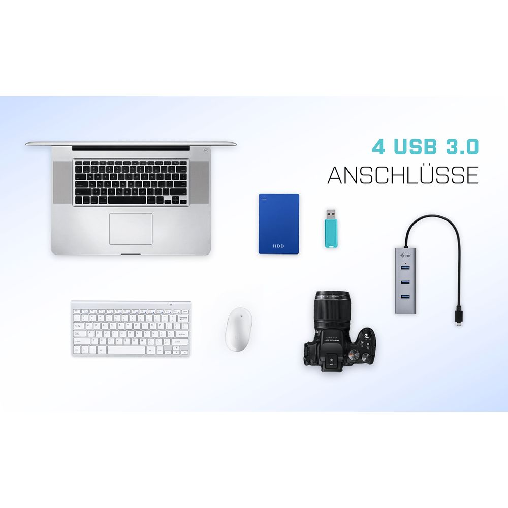 Portátil, teclado, ratón, disco duro, pendrive, cámara y hub USB sobre fondo blanco.