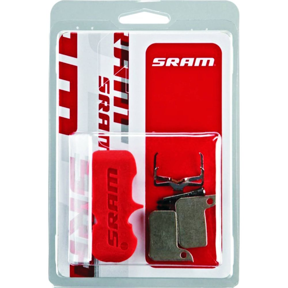 Klocki hamulcowe SRAM w opakowaniu z czerwonym narzędziem i metalowymi częściami.