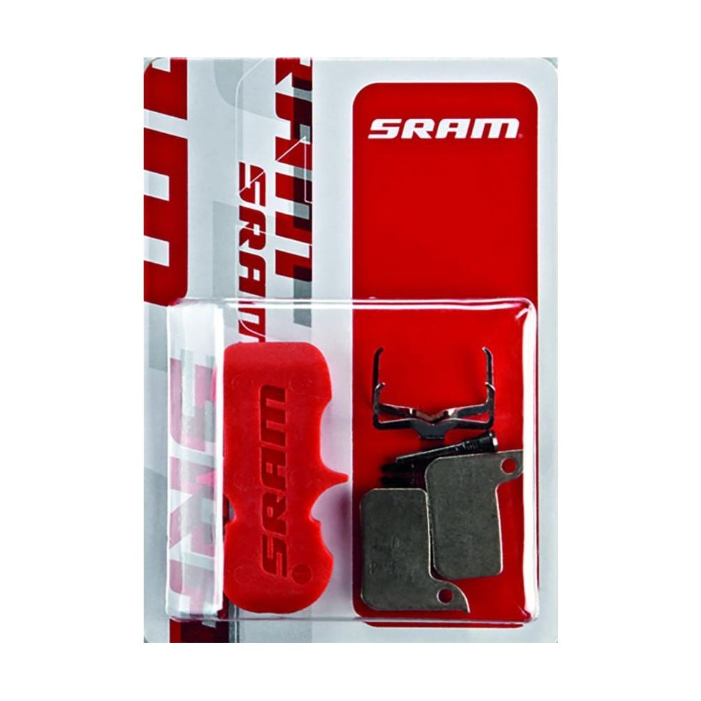 Klocki hamulcowe rowerowe SRAM w czerwonym opakowaniu z srebrnymi klockami i narzędziem.