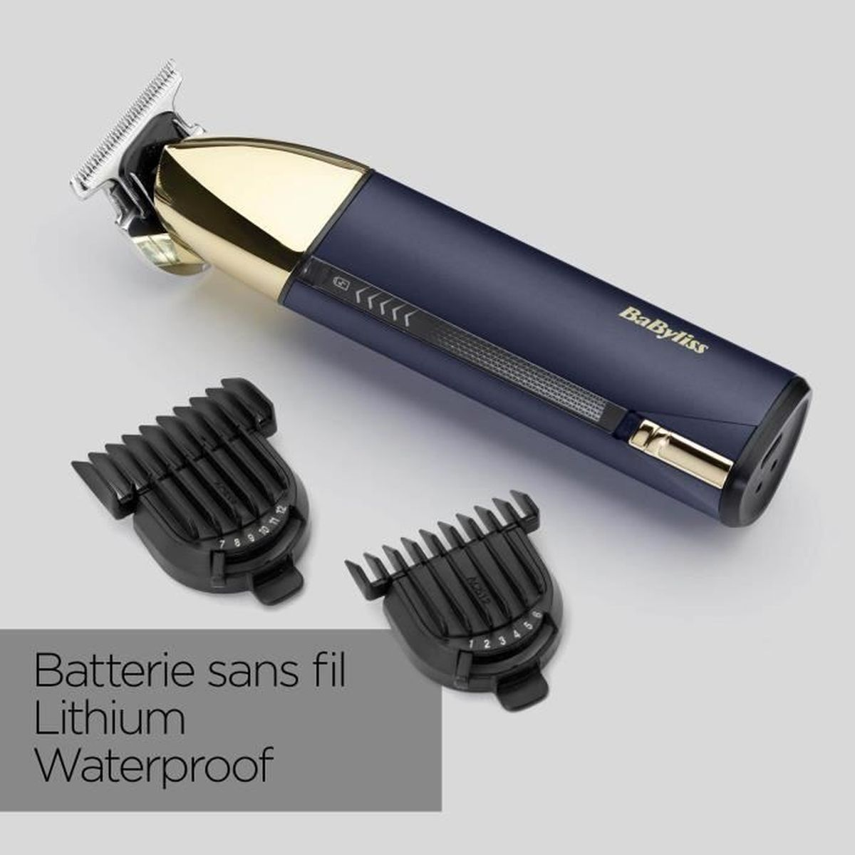 A dark blue hair clipper with a gold cap and two attachments.