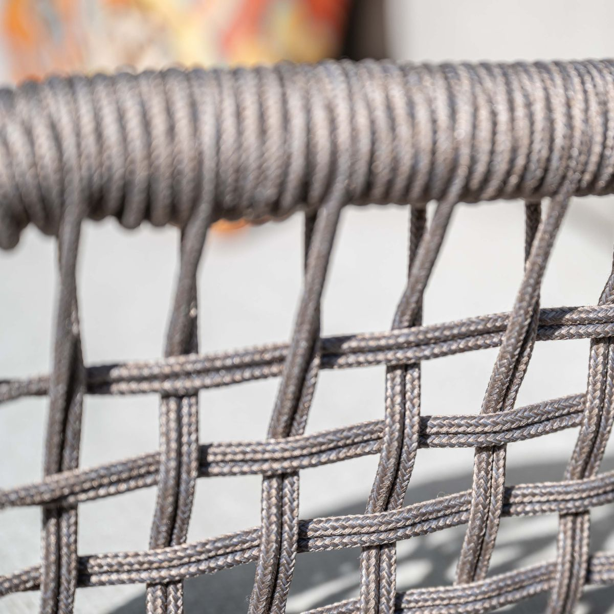 Close-up of a grey rope weave texture forming a pattern.