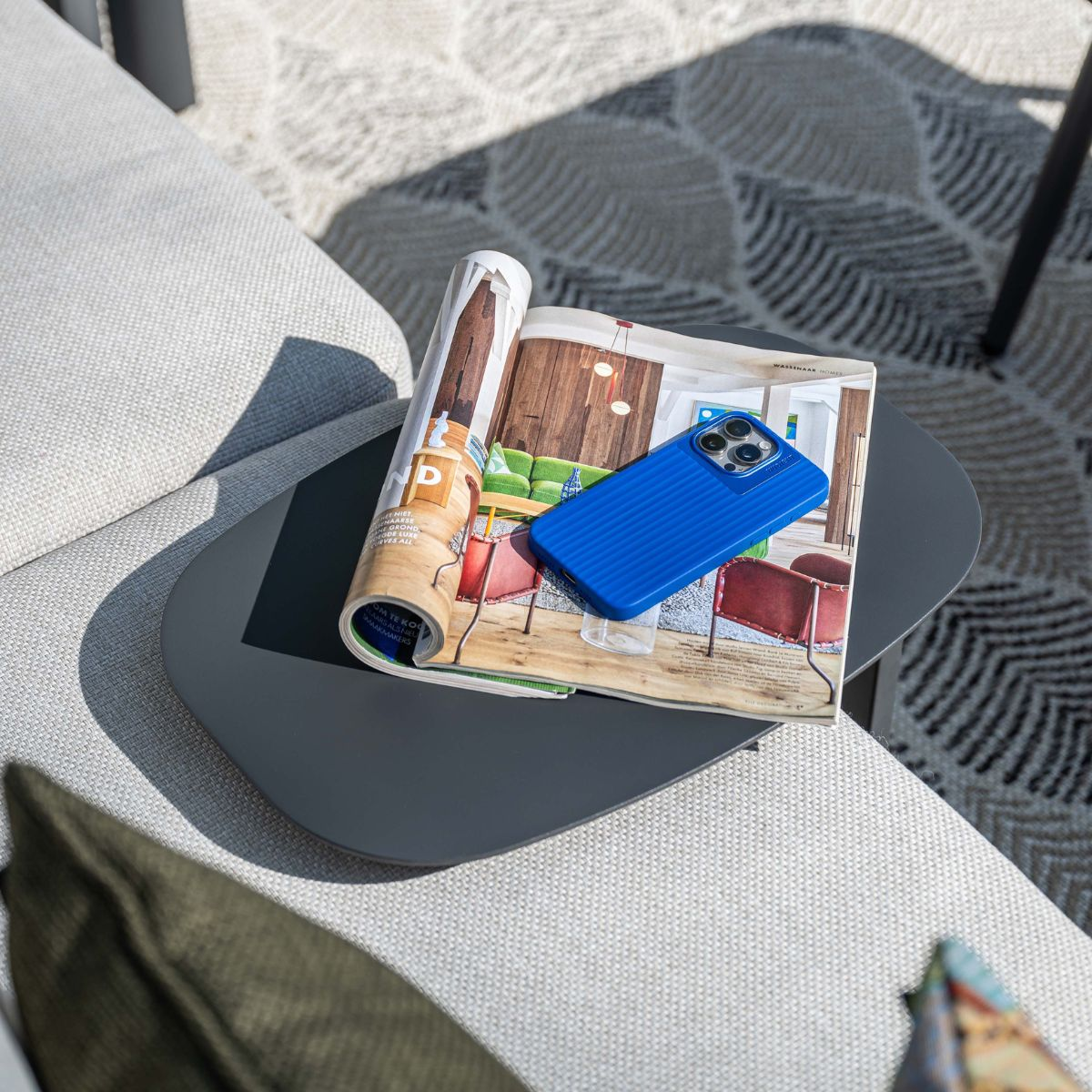 Blue phone case on an open magazine on a table.
