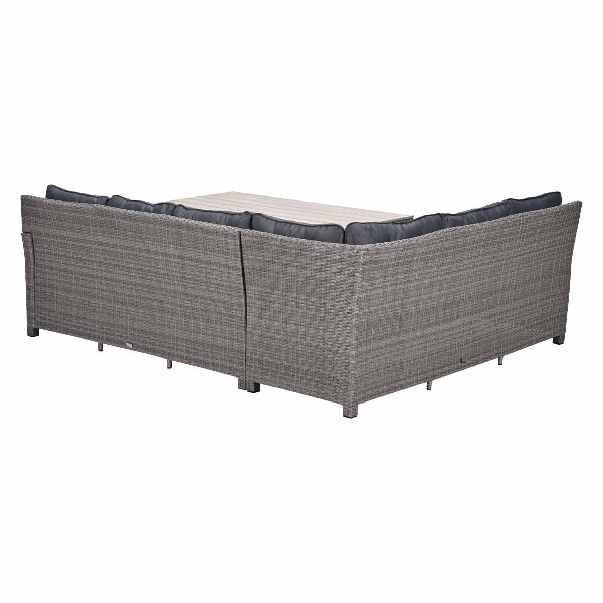 Gray rattan sectional sofa with a table and dark cushions.
