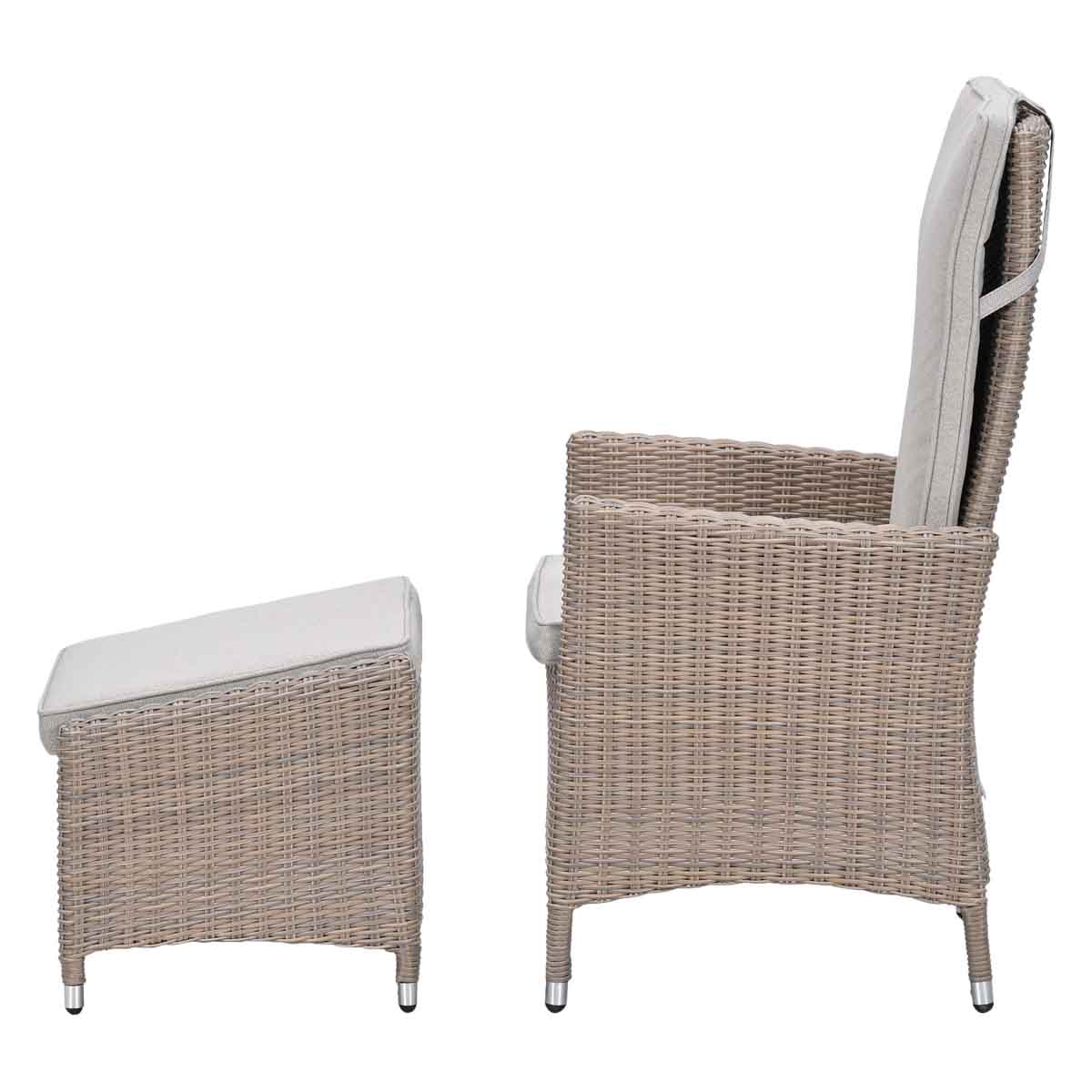 A light rattan armchair with cushions and a matching footstool.