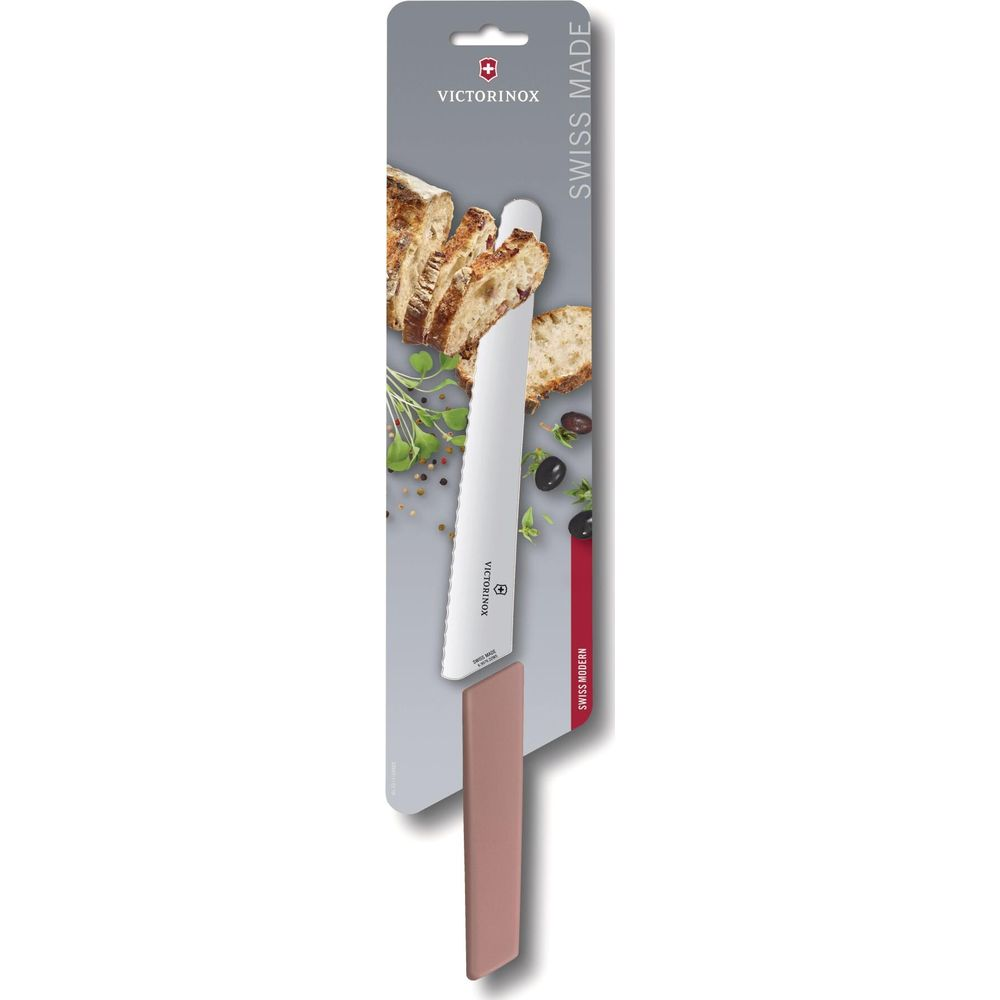 Ein weißes Victorinox Brotmesser mit gezackter Klinge, daneben Brot und Oliven.