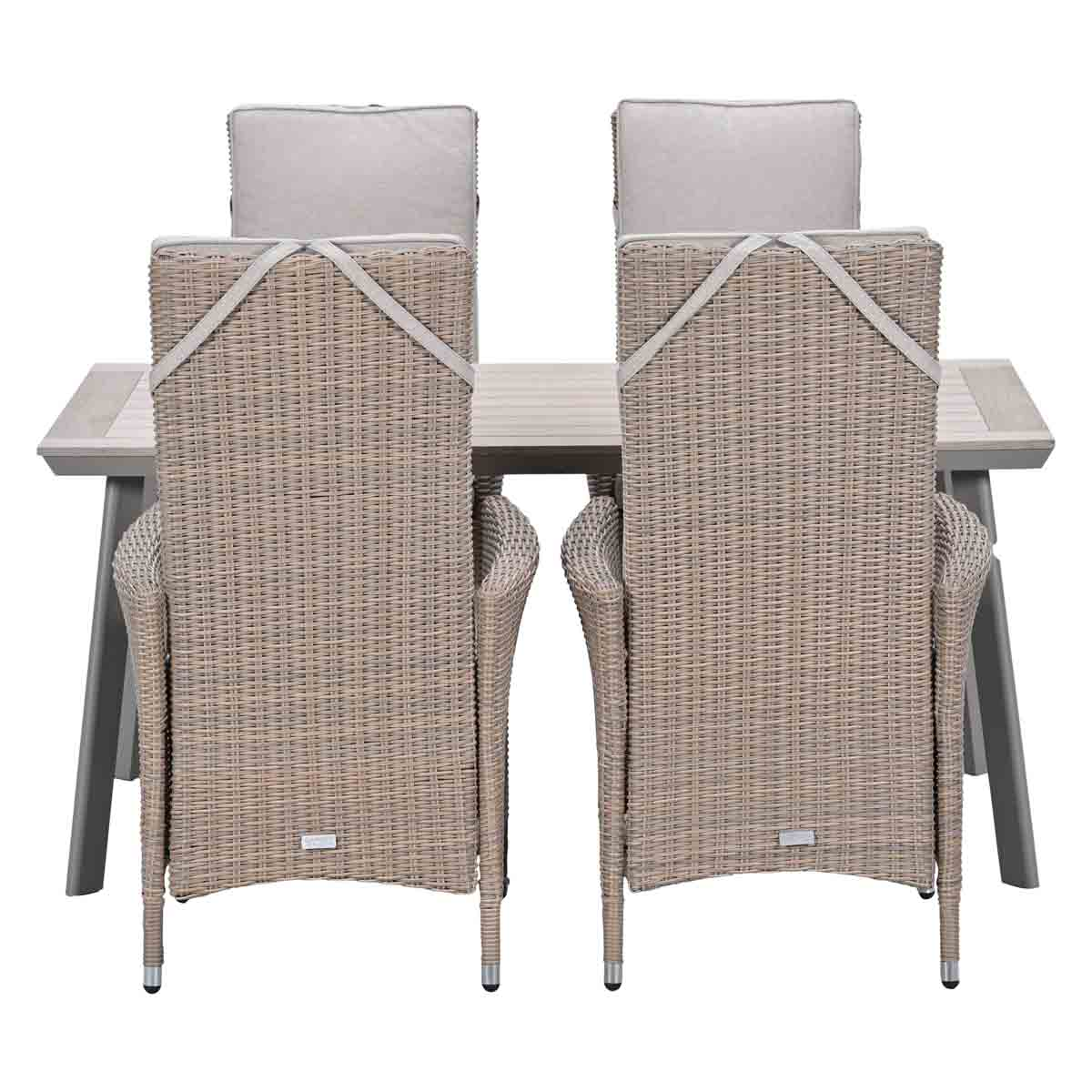 Two wicker chairs with light cushions are positioned at a wood and metal table.