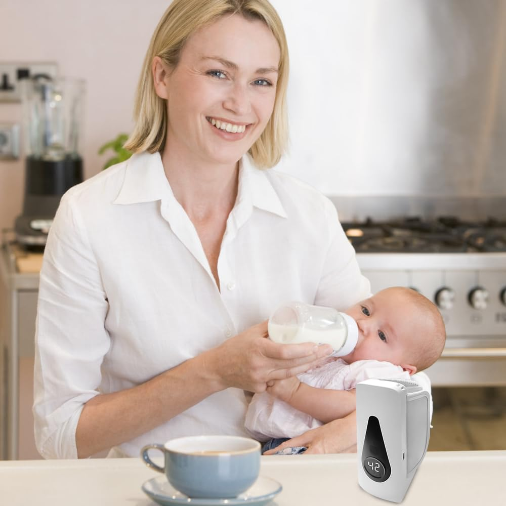 Eine Frau mit blonden Haaren füttert ein Baby mit einer Milchflasche in einer Küche.