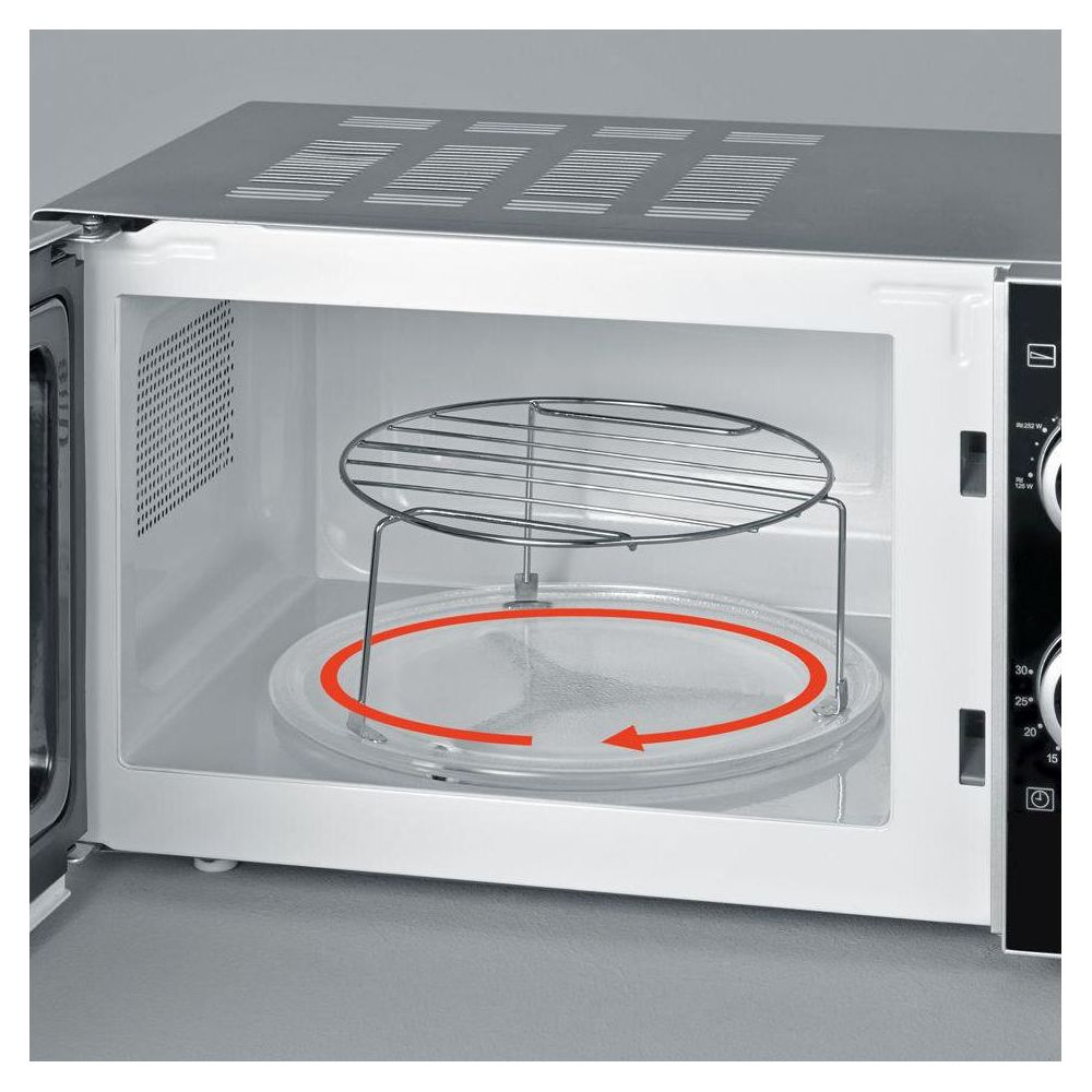 Vue intérieure d'un micro-ondes avec une grille sur un plateau en verre.