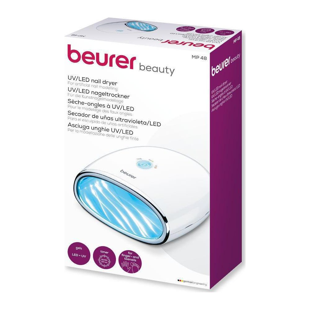Ein weißer Beurer UV/LED-Nageltrockner mit blauen Lichtern, auf einer Verpackung.