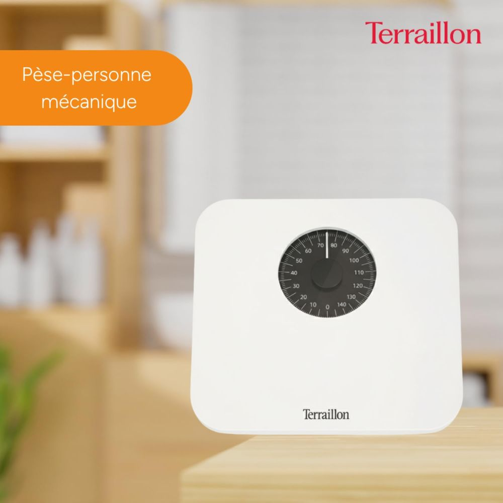 Biała waga mechaniczna z okrągłą tarczą i logo Terraillon.