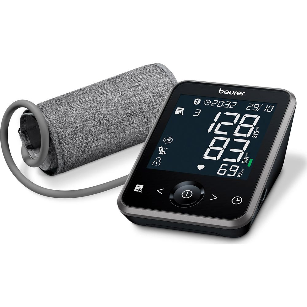 A Beurer blood pressure monitor with cuff and digital display showing readings.