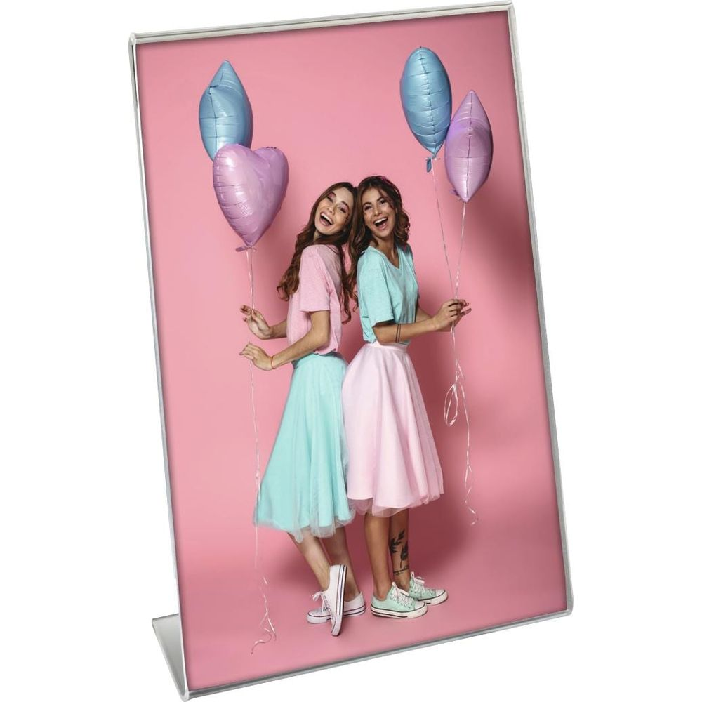 Zwei junge Frauen mit Luftballons vor rosafarbenem Hintergrund.