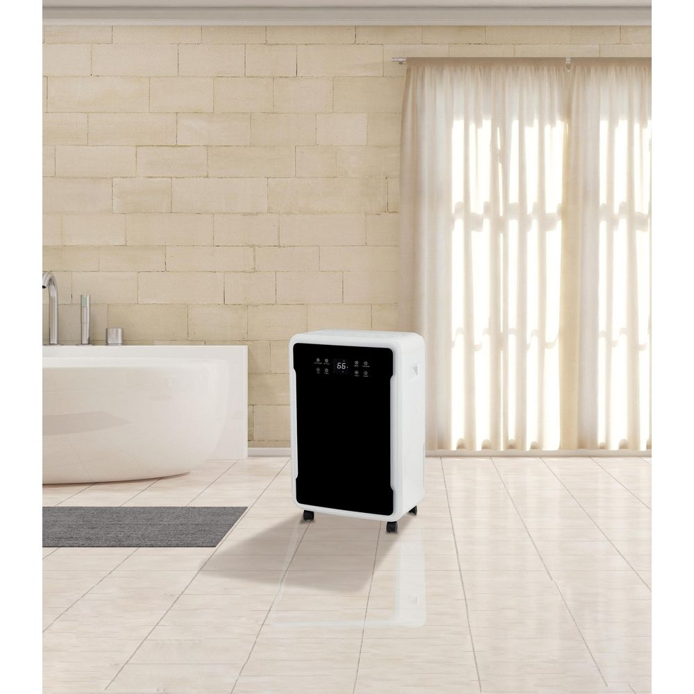 Un deumidificatore bianco con frontale nero si trova su un pavimento piastrellato.