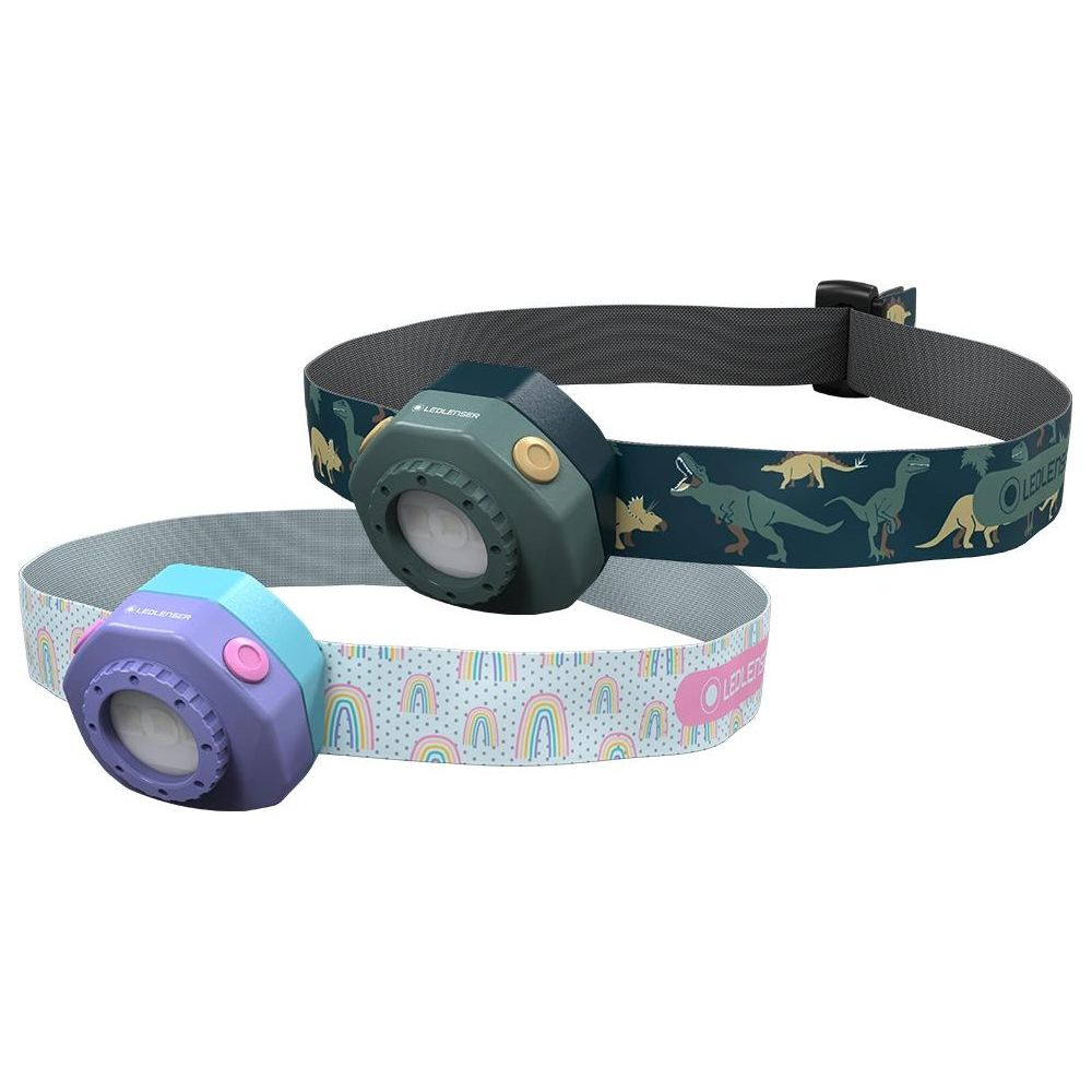 Zwei LED Lenser Stirnlampen: eine grüne mit Dinosauriern, eine lila mit Regenbogen.