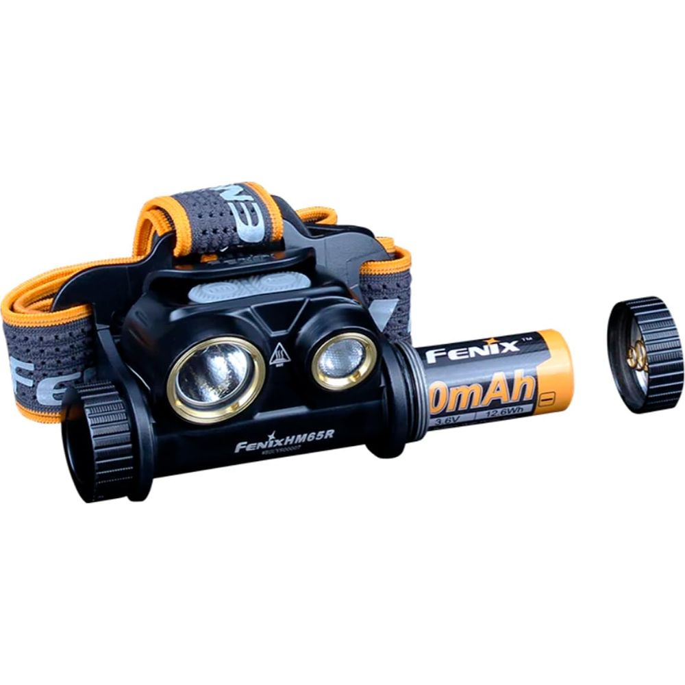 Un phare noir avec sangle orange, deux lentilles et une batterie amovible.