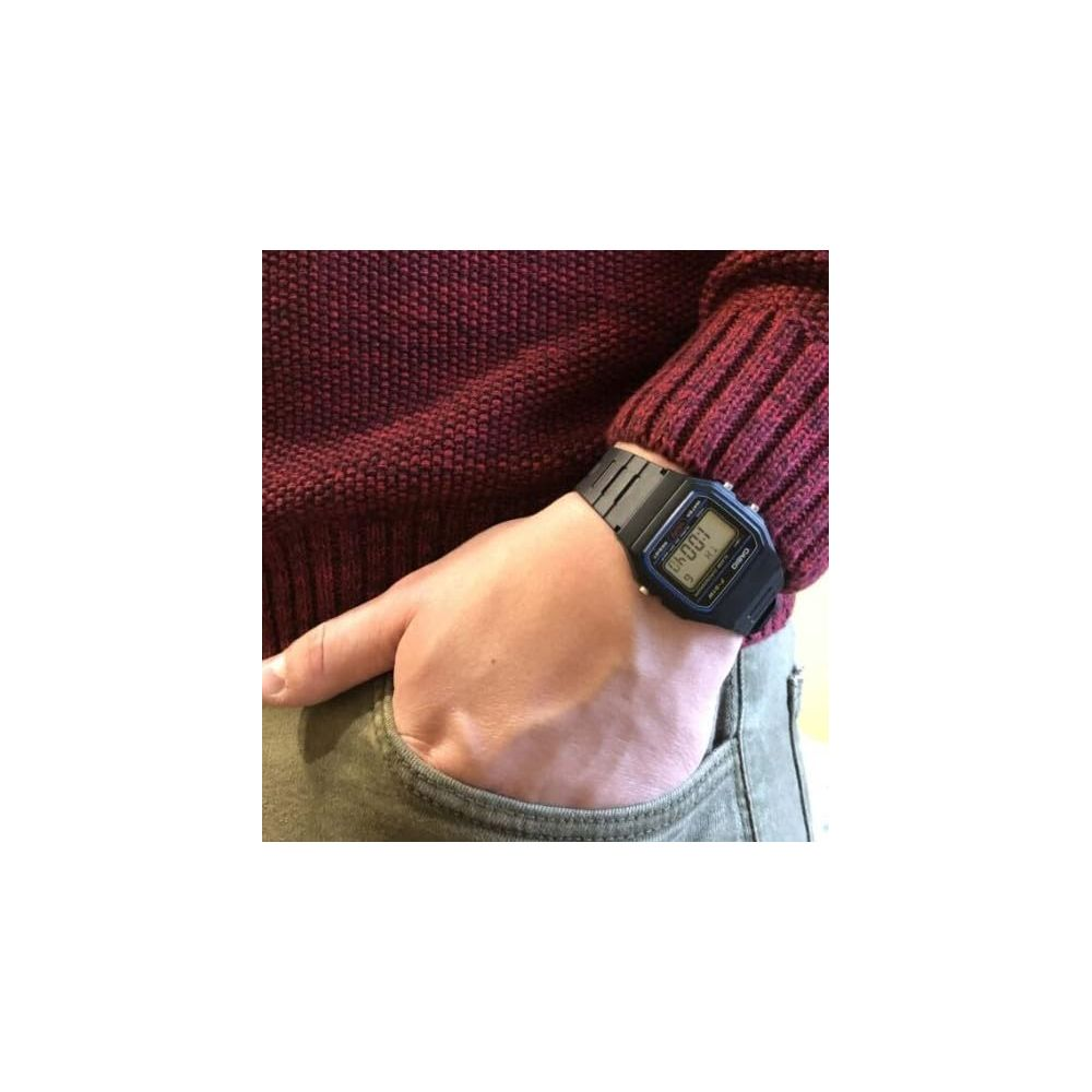Una persona lleva un suéter rojo oscuro y un reloj digital Casio negro.