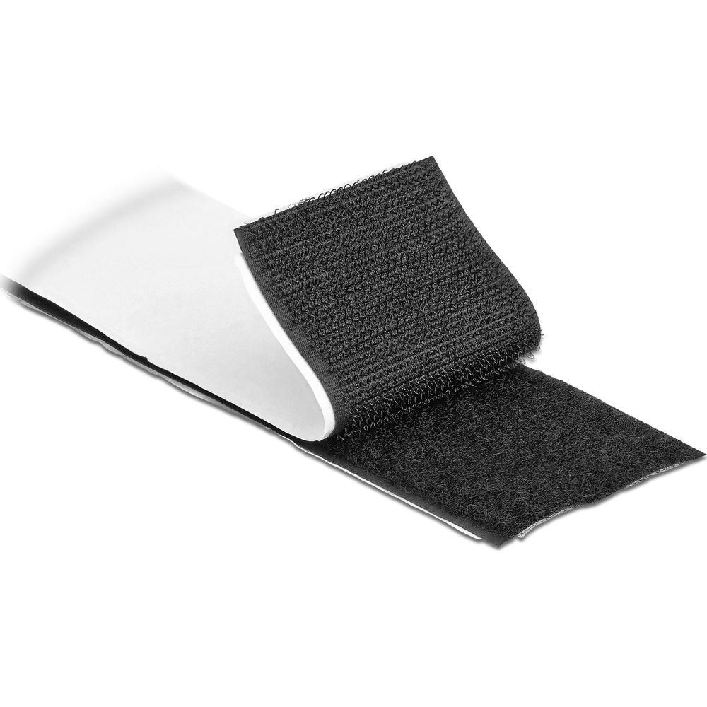 Cinta de velcro negra con adhesivo blanco, parcialmente desplegada.