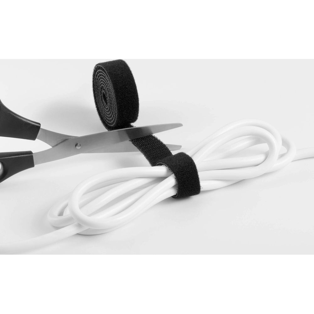 Schwarzes Klettband wird mit einer Schere durchtrennt, das ein weißes Kabel umwickelt.