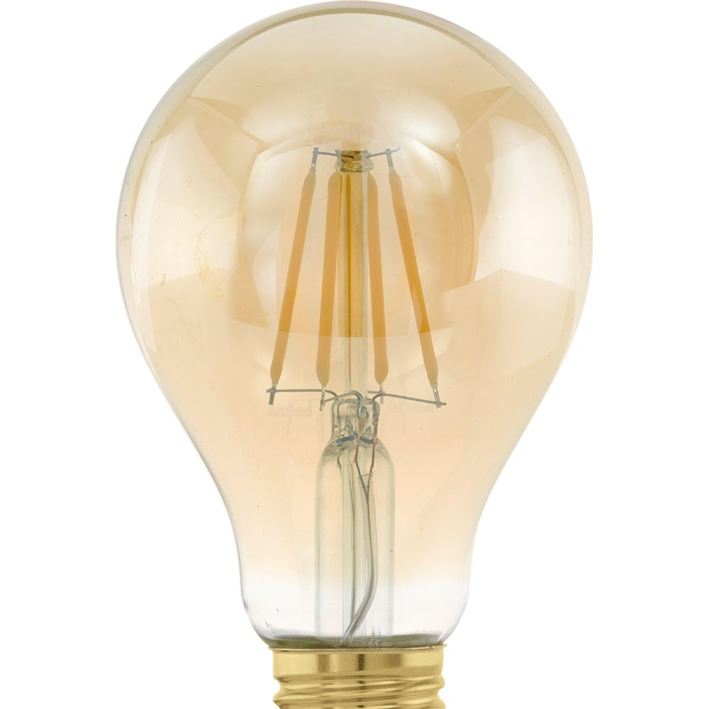 Une ampoule de couleur ambre avec des filaments visibles sur fond blanc.