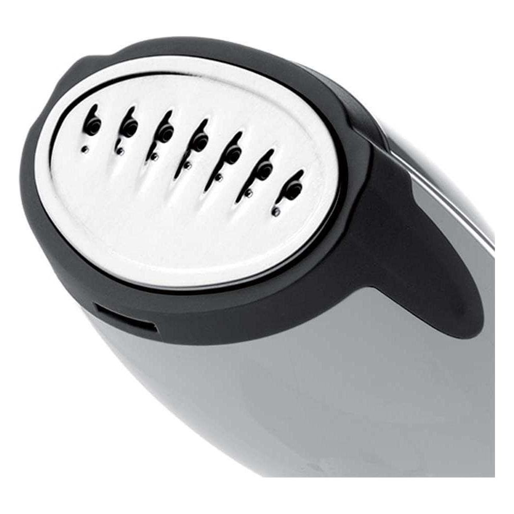 Zbliżenie na stopę parową żelazka z sześcioma otworami parowymi.