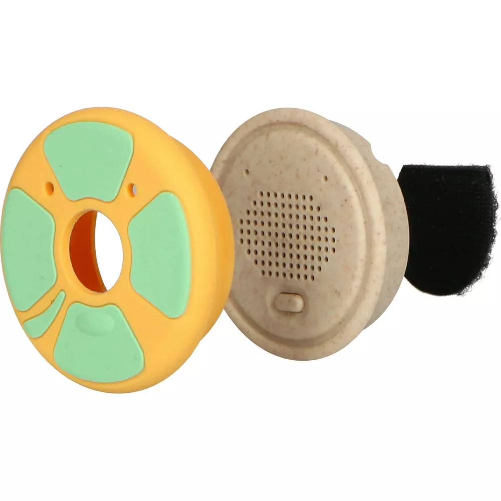 Yellow object with green accents, beige speaker cover, black foam piece.