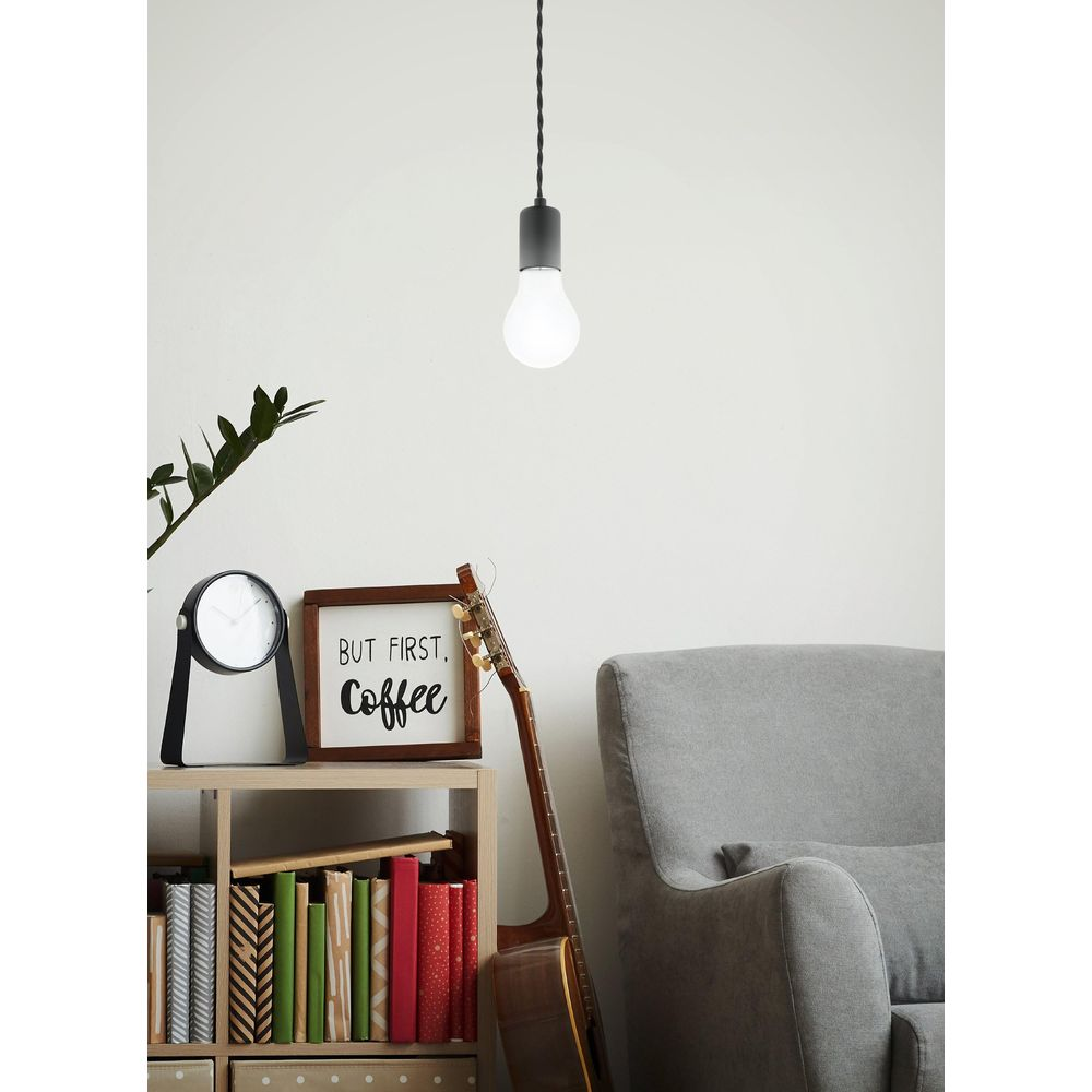 Une étagère avec des livres, une guitare, une pancarte et un fauteuil.