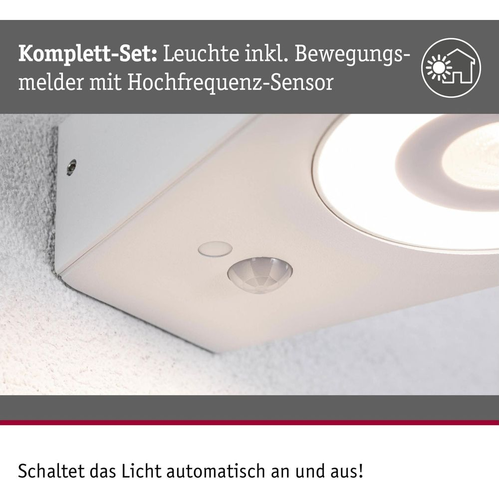 Biała lampa z czujnikiem ruchu i czujnikiem HF zamontowana na ścianie.