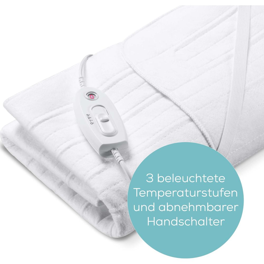 Ein weißes Heizkissen mit weißem Regler und Kabel.