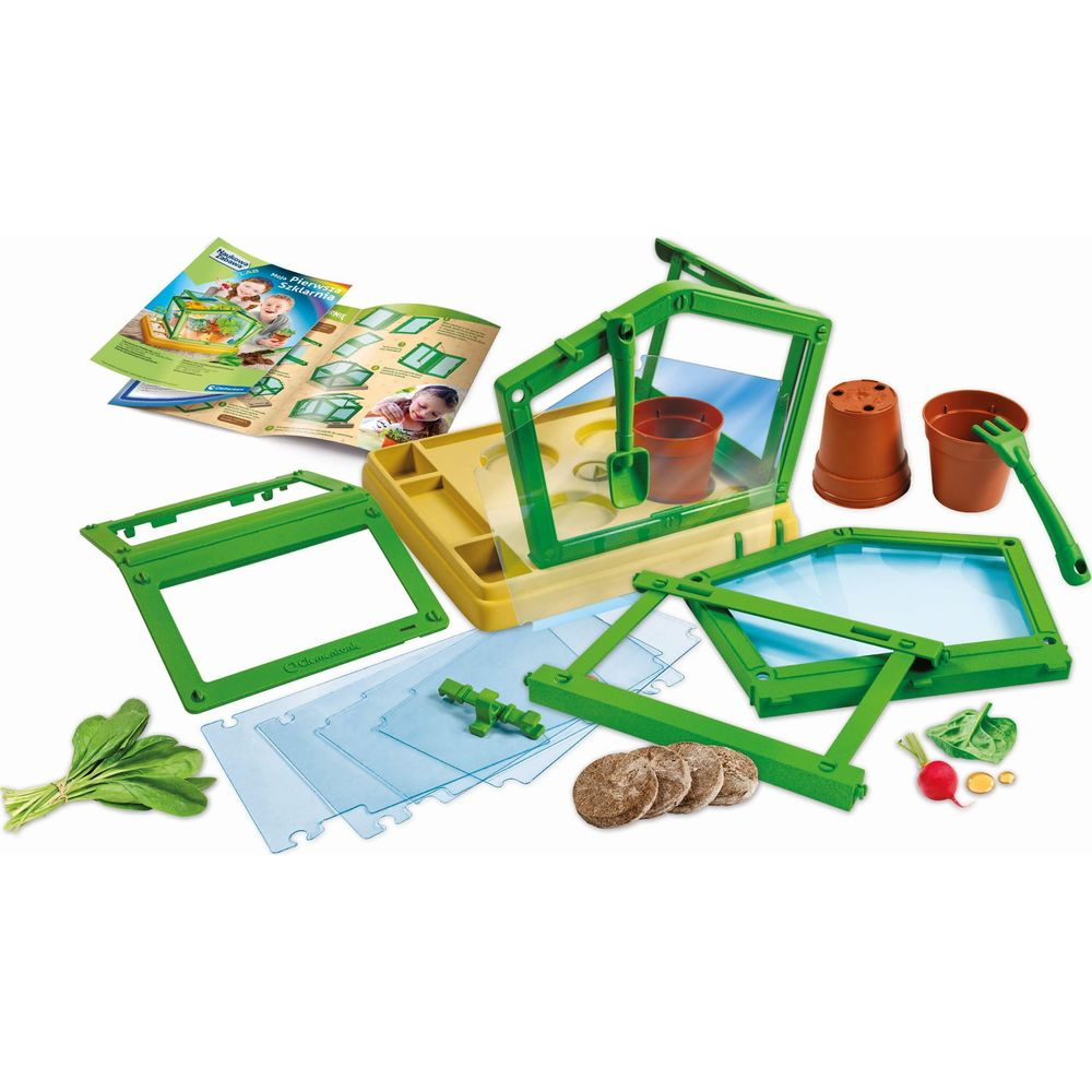 Ein Spielzeug-Gewächshaus-Set mit grünen und gelben Teilen, Töpfen, Werkzeugen und Pflanzen.