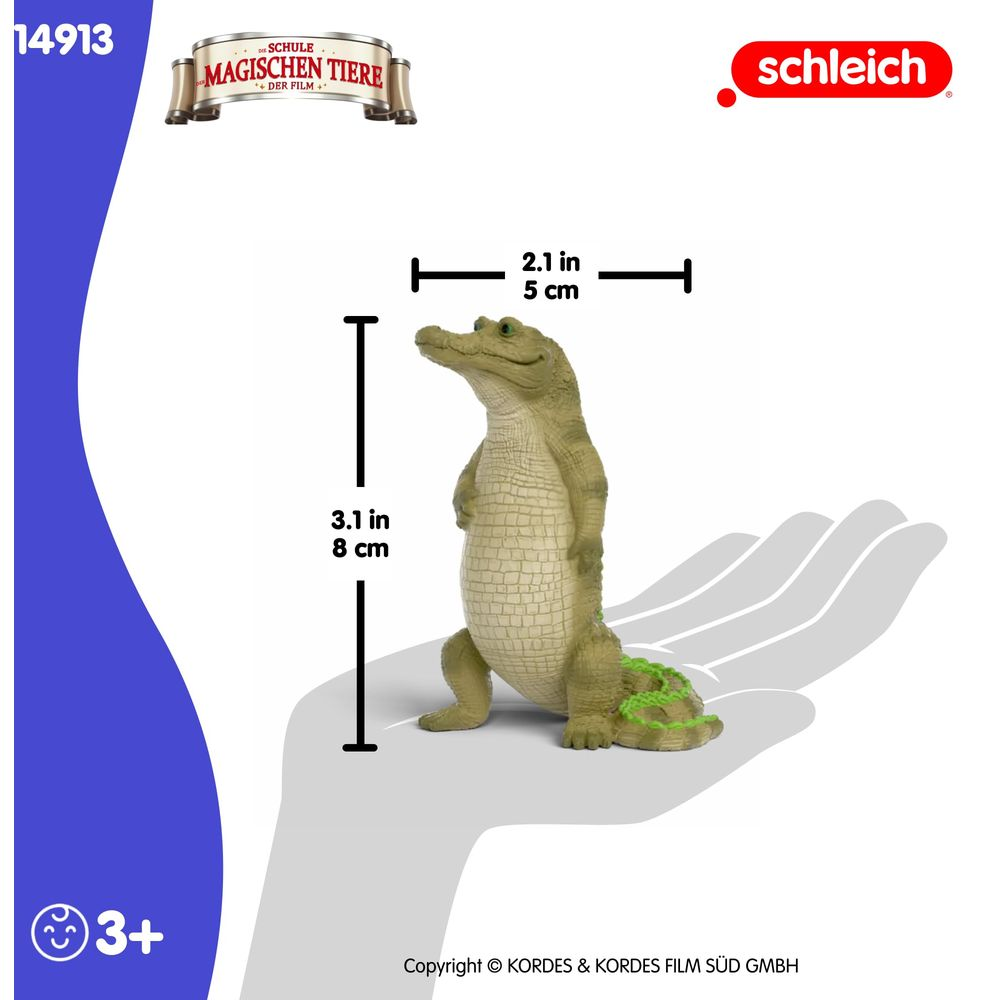 Une figurine de crocodile vert se tient droite. Dimensions indiquées.