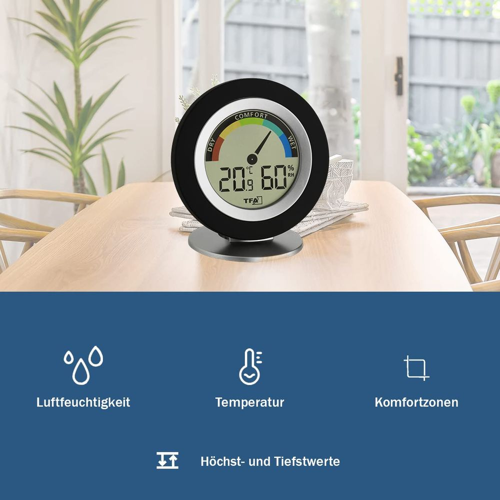 Ein digitaler Hygrometer auf einem Holztisch zeigt 20.9°C und 60% Luftfeuchtigkeit.