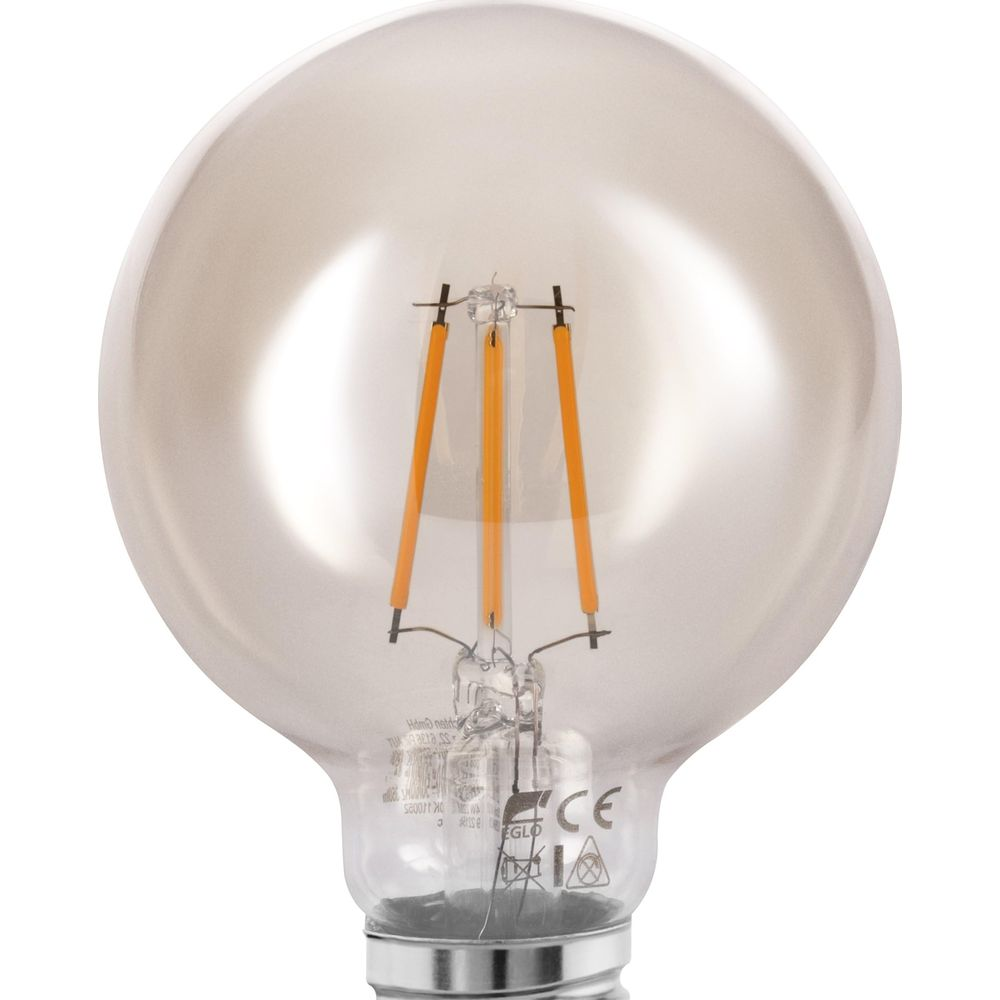 Una lampadina trasparente con filamento arancione, primo piano.